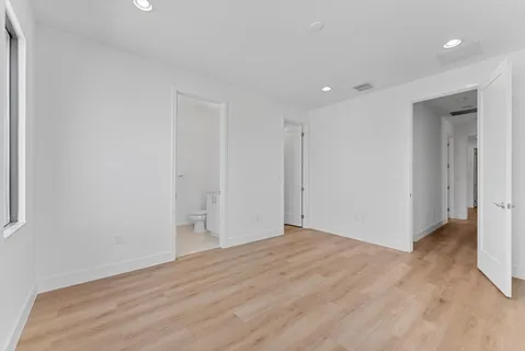 an aerial view of residential houses with outdoor space and ocean view