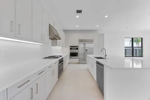 a living room with furniture and large windows