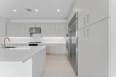 a view of kitchen with furniture and refrigerator