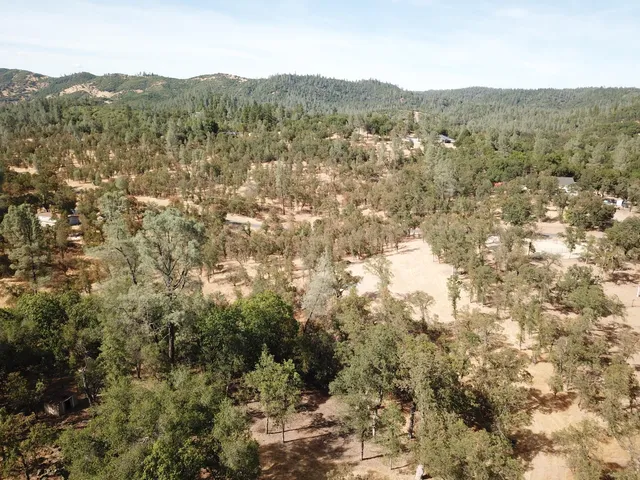 a view of a snow with trees in the background