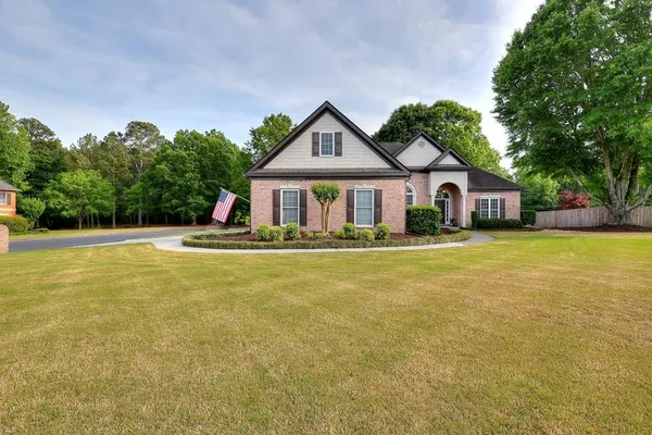 a front view of house with yard and green space