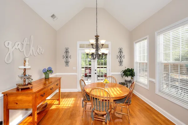 a large kitchen with kitchen island a large counter top space a sink stainless steel appliances and cabinets