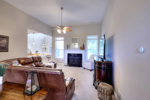 a living room with furniture and a chandelier
