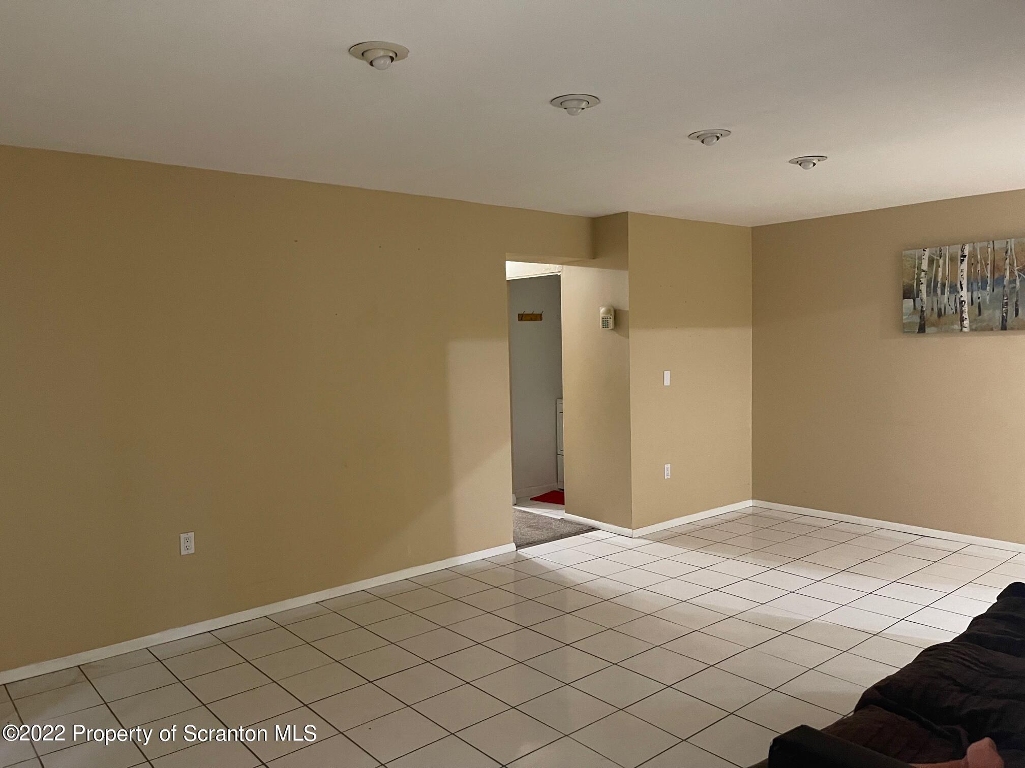 1501 Summit Pointe Scranton, PA 18508 - Photo 4 of 12 a bedroom with a bed and a painting on the wall