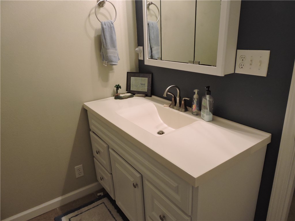 1901 Hattons Ford Road Townville, SC 29689 - Photo 21 of 33 A well-appointed vanity with ample counter space and integrated sink offers practical elegance.
