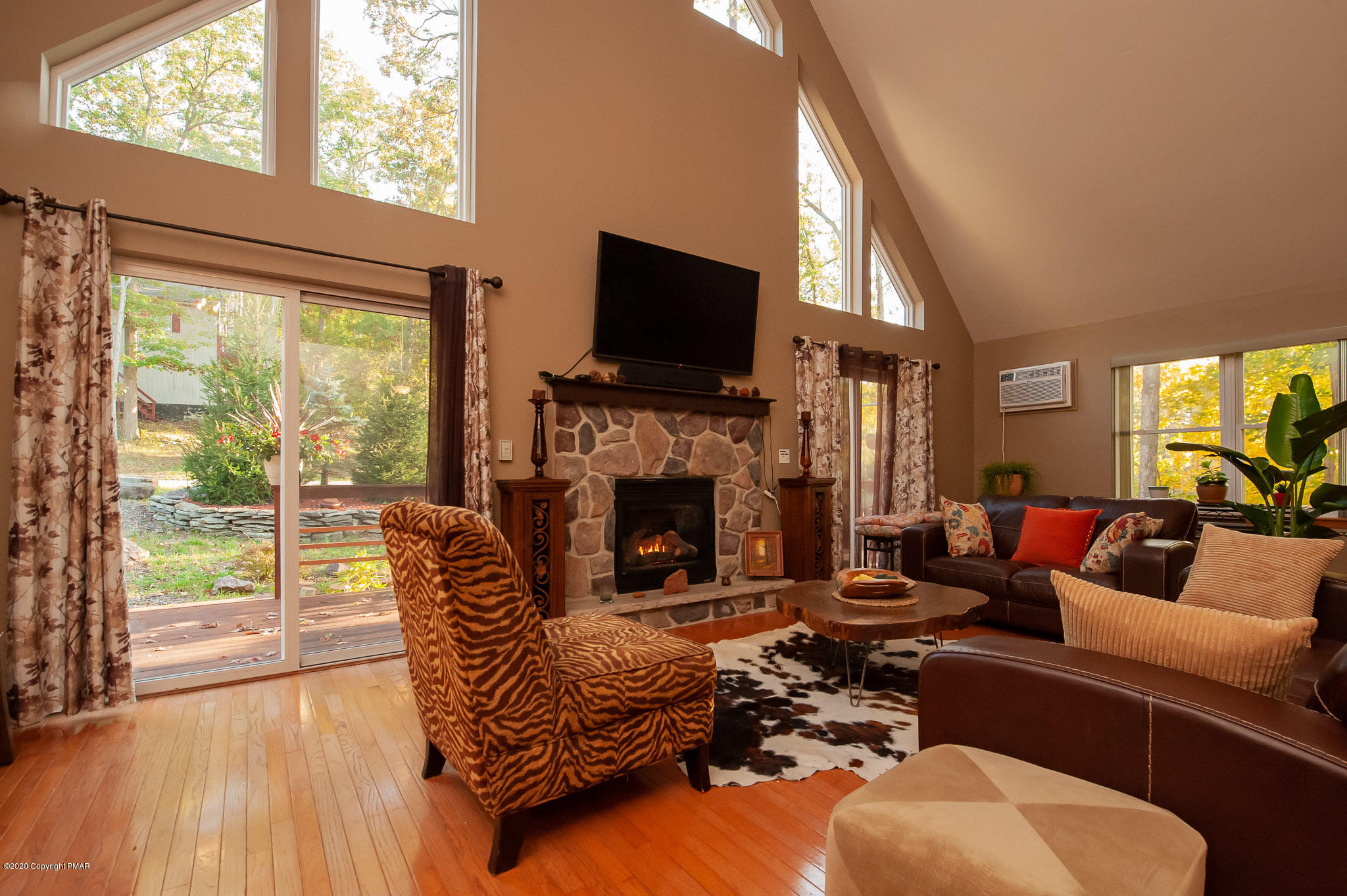 145 Salisbury Road Bushkill, PA 18324 - Photo 31 of 60 a living room with furniture a flat screen tv and a fireplace