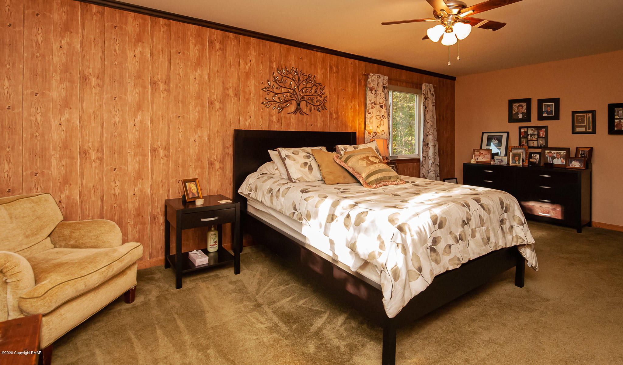 145 Salisbury Road Bushkill, PA 18324 - Photo 38 of 60 a bed sitting in a bedroom next to a lamp with a chandelier