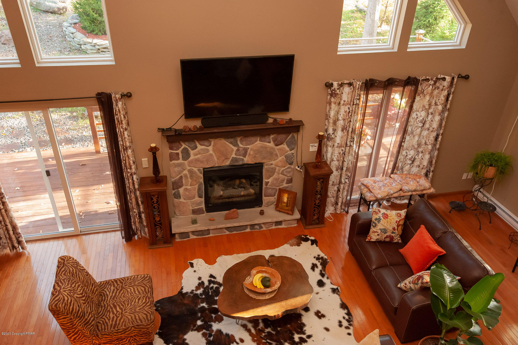 145 Salisbury Road Bushkill, PA 18324 - Photo 52 of 60 a living room with furniture a flat screen tv and a fireplace
