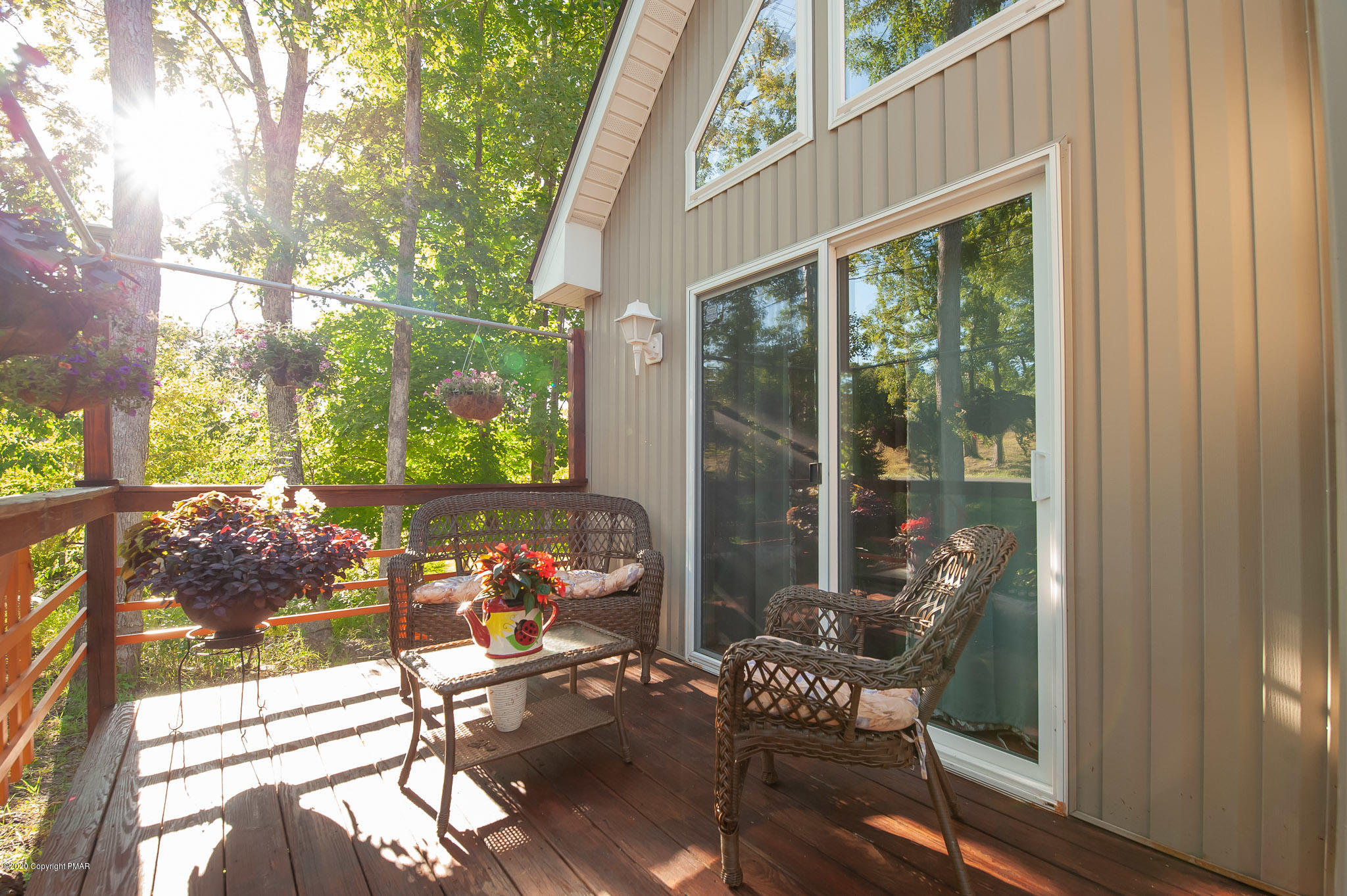 145 Salisbury Road Bushkill, PA 18324 - Photo 56 of 60 a view of a patio with table and chairs and floor to ceiling window and wooden fence