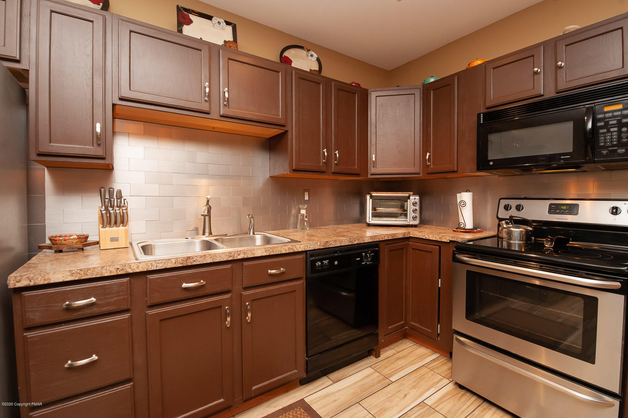 145 Salisbury Road Bushkill, PA 18324 - Photo 6 of 60 a kitchen with stainless steel appliances granite countertop a sink stove and microwave
