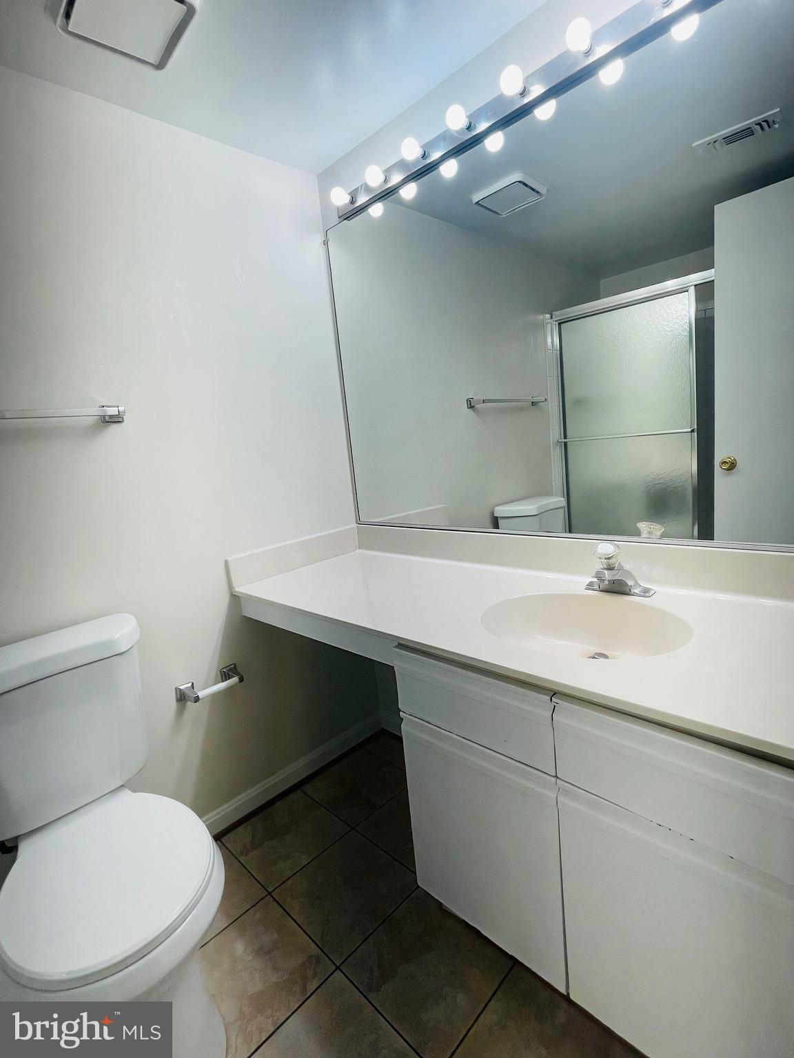 14229 Bowsprit Lane, Unit 501 Laurel, MD 20707 - Photo 11 of 19 a bathroom with a toilet sink and mirror