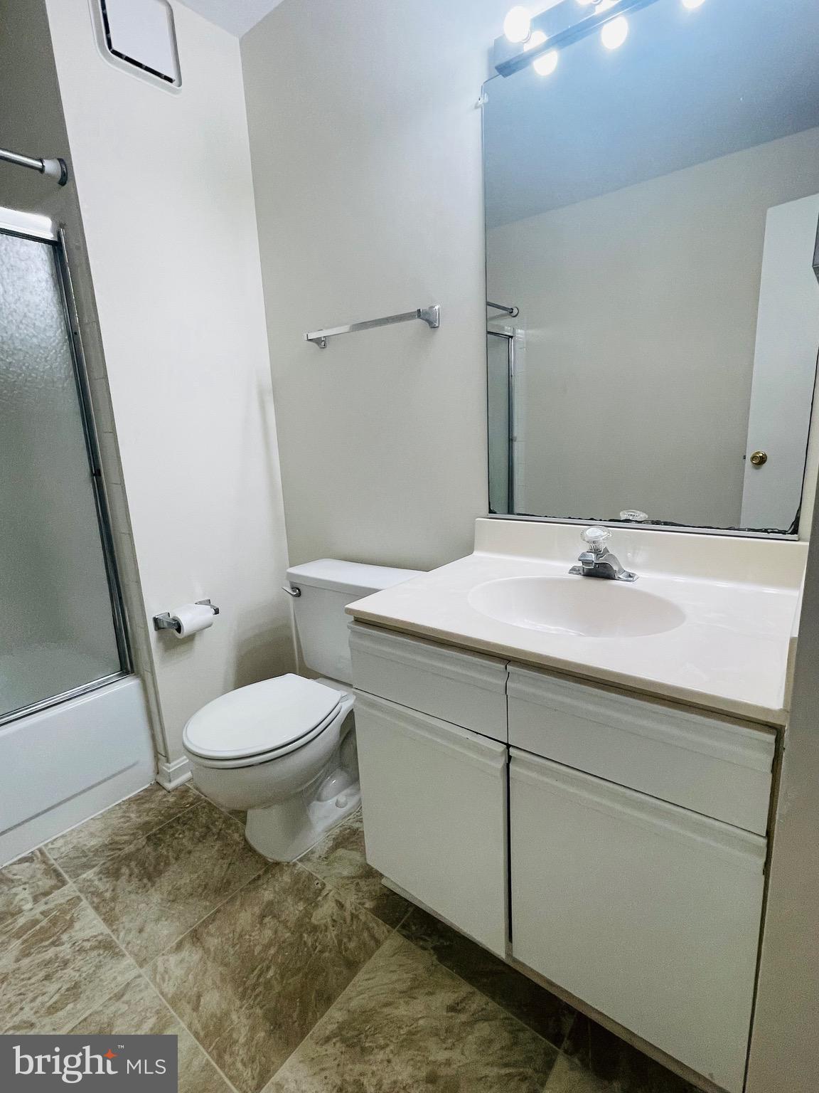 14229 Bowsprit Lane, Unit 501 Laurel, MD 20707 - Photo 16 of 19 a bathroom with a sink a toilet and a mirror