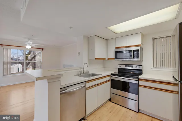 a kitchen with sink and refrigerator
