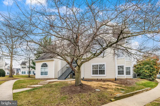 a view of a house with a yard covered in snow