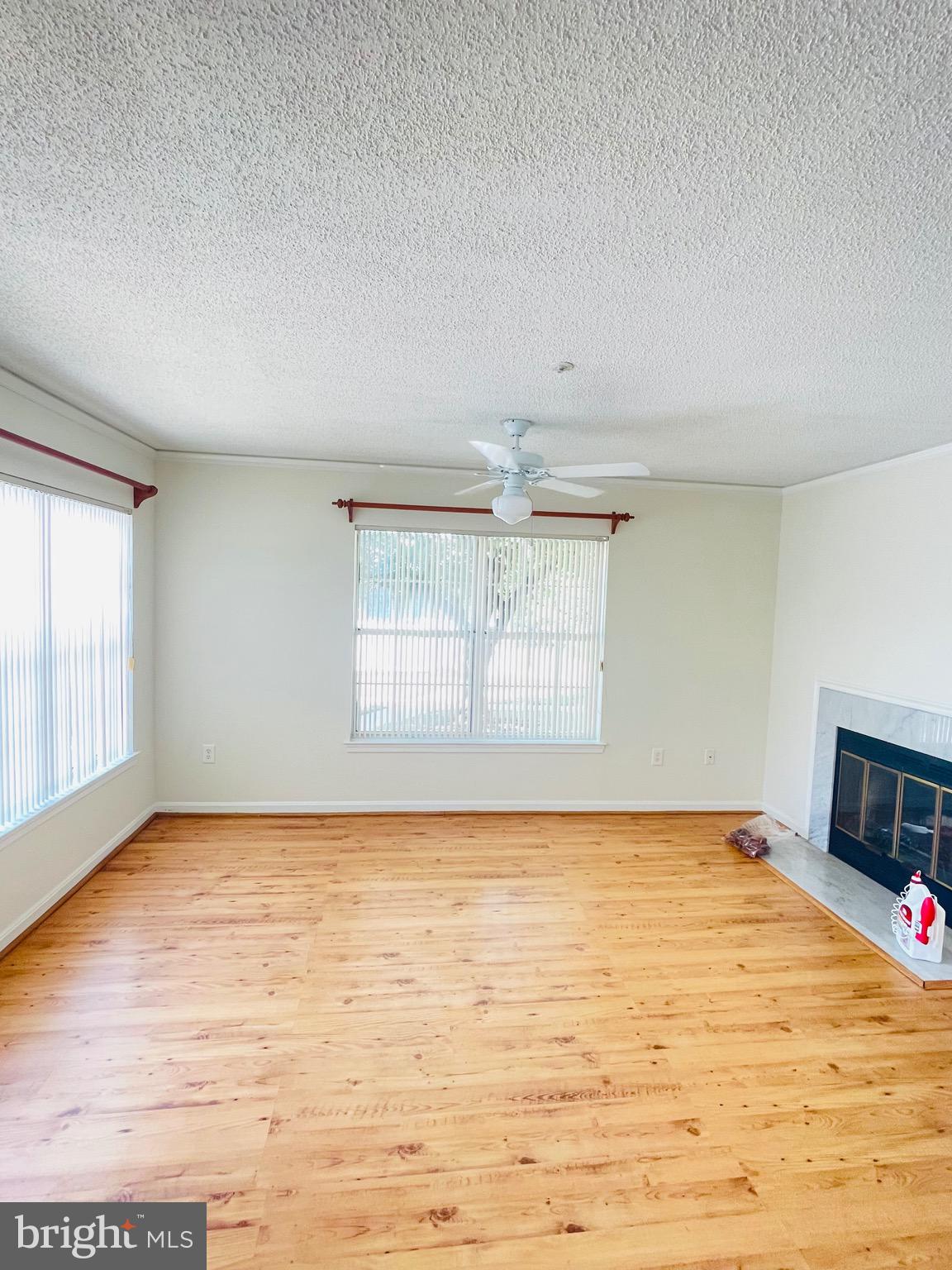 14229 Bowsprit Lane, Unit 501 Laurel, MD 20707 - Photo 3 of 19 a view of an empty room with a window and wooden floor