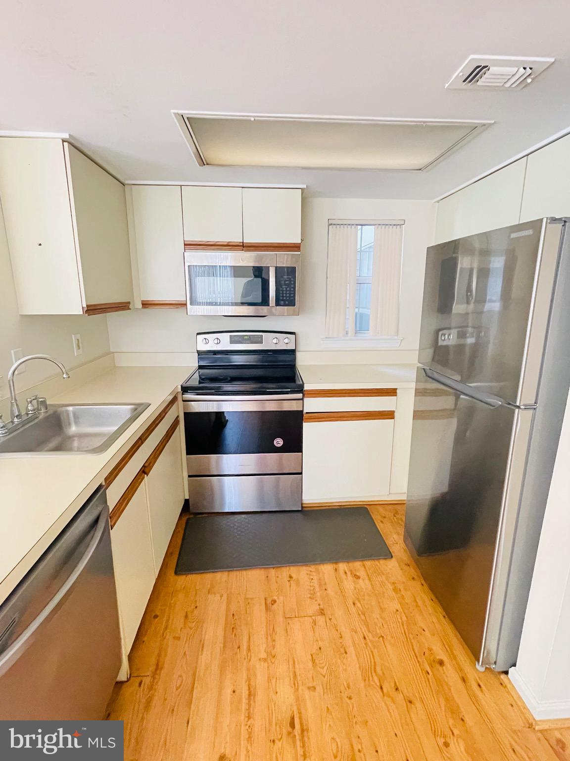 14229 Bowsprit Lane, Unit 501 Laurel, MD 20707 - Photo 5 of 19 a kitchen with stainless steel appliances a refrigerator and a sink
