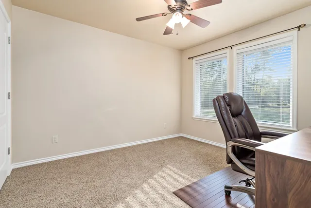 a view of workspace with wooden floor and windows