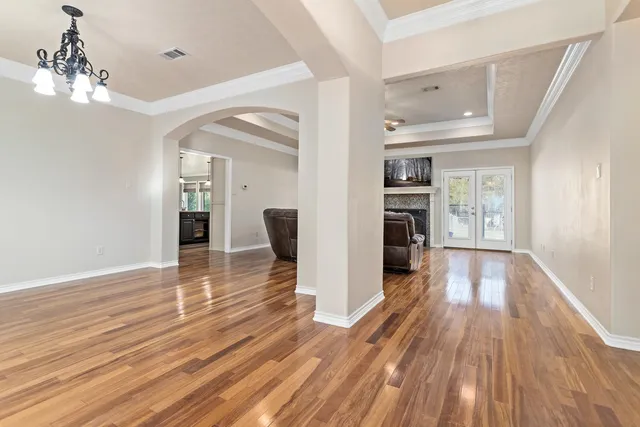 a view of a hallway view with wooden floor and a fireplace