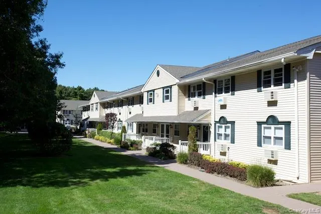 a front view of a house with a yard table and chairs