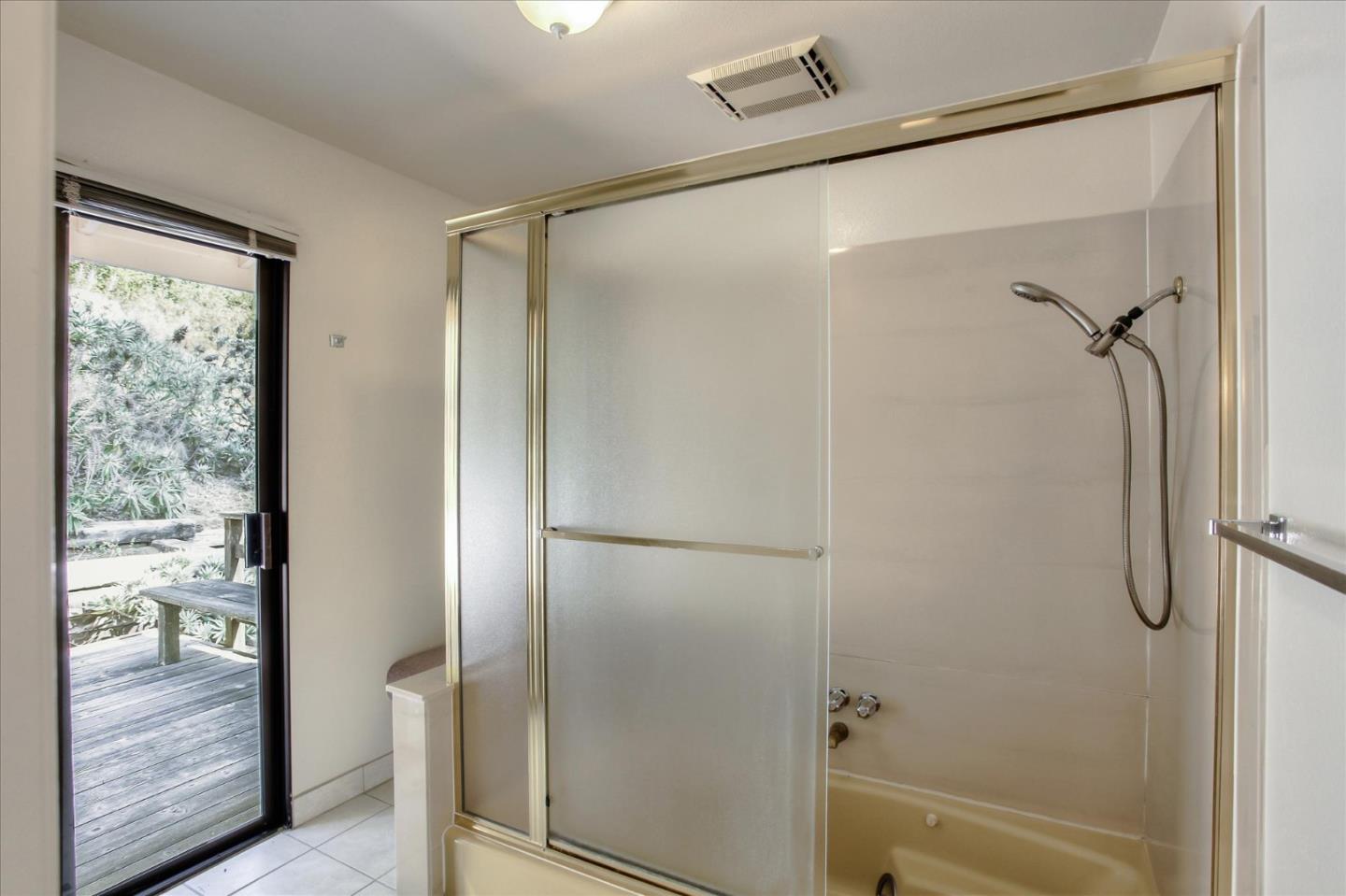 4060 Crest Road Pebble Beach, CA 93953 - Photo 42 of 54 a bathroom with a glass shower door
