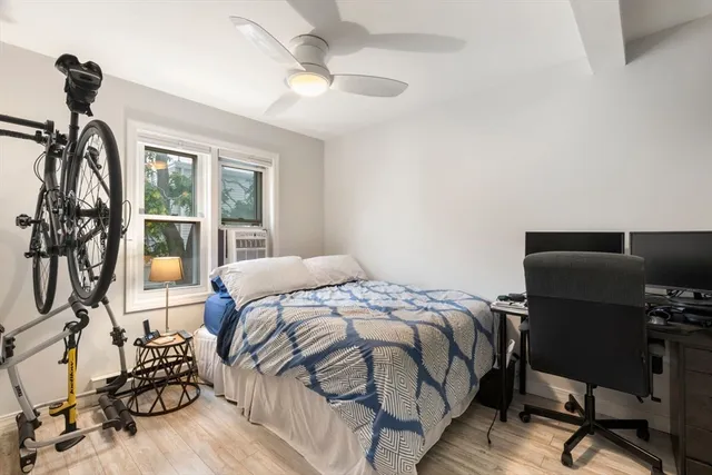 a bedroom with a bed and a desk