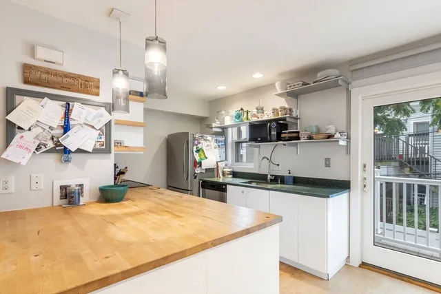 a kitchen with stainless steel appliances granite countertop a sink and a stove