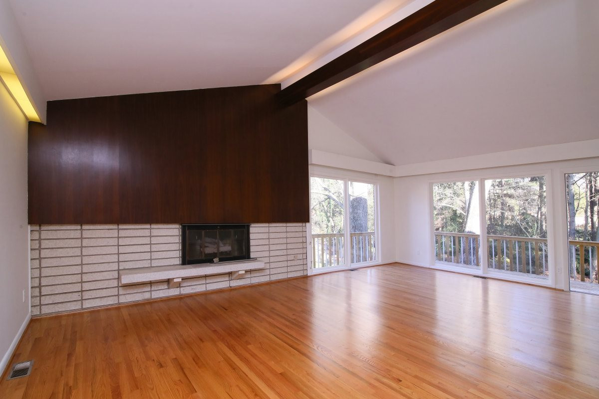 5416 Alpine Drive Raleigh, NC 27609 - Photo 3 of 25 Love this mid-century modern fireplace in the living room. Cathedral ceilings and wood floors. The wood floors in the house have been newly refinished. Living Room