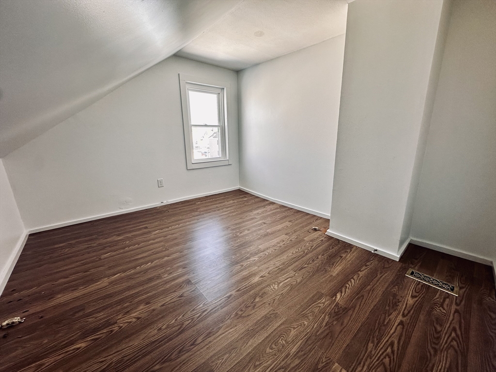 12 Thorndike Street, Unit 2 Salem, MA 01970 - Photo 15 of 16 an empty room with wooden floor and windows