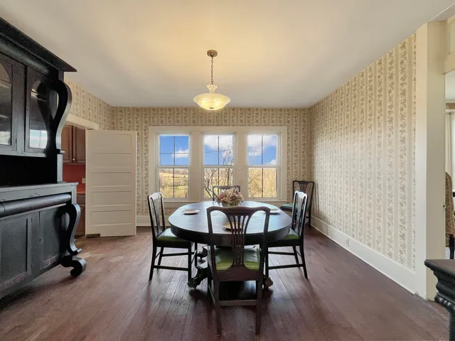 a bathroom with a granite countertop toilet sink and mirror