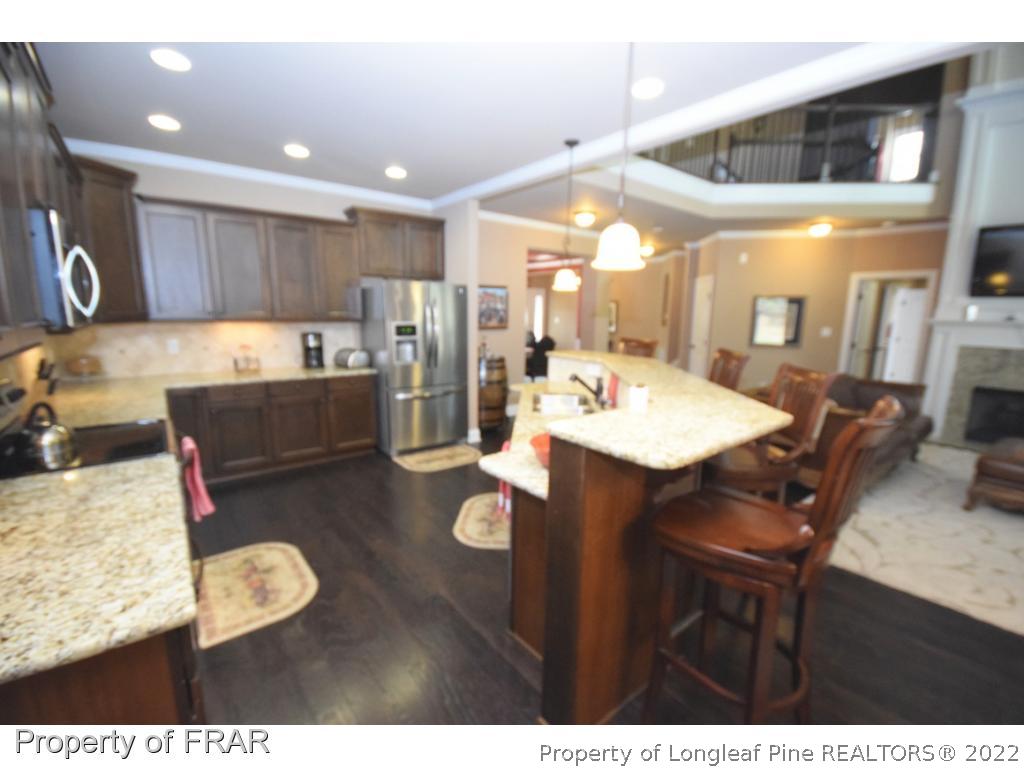 1804 Micahs Way North Spring Lake, NC 28390 - Photo 13 of 30 a kitchen with a dining table chairs and view kitchen
