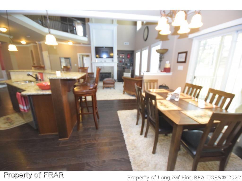 1804 Micahs Way North Spring Lake, NC 28390 - Photo 14 of 30 a view of a dining room with furniture and wooden floor