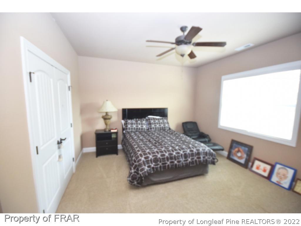 1804 Micahs Way North Spring Lake, NC 28390 - Photo 17 of 30 a bedroom with a bed and a window