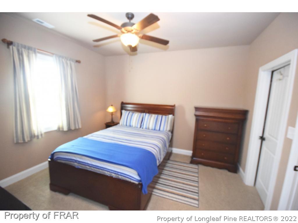 1804 Micahs Way North Spring Lake, NC 28390 - Photo 20 of 30 a bedroom with a bed and a dresser
