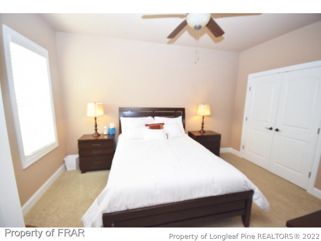 1804 Micahs Way North Spring Lake, NC 28390 - Photo 22 of 30 a bedroom with a bed and wooden floor