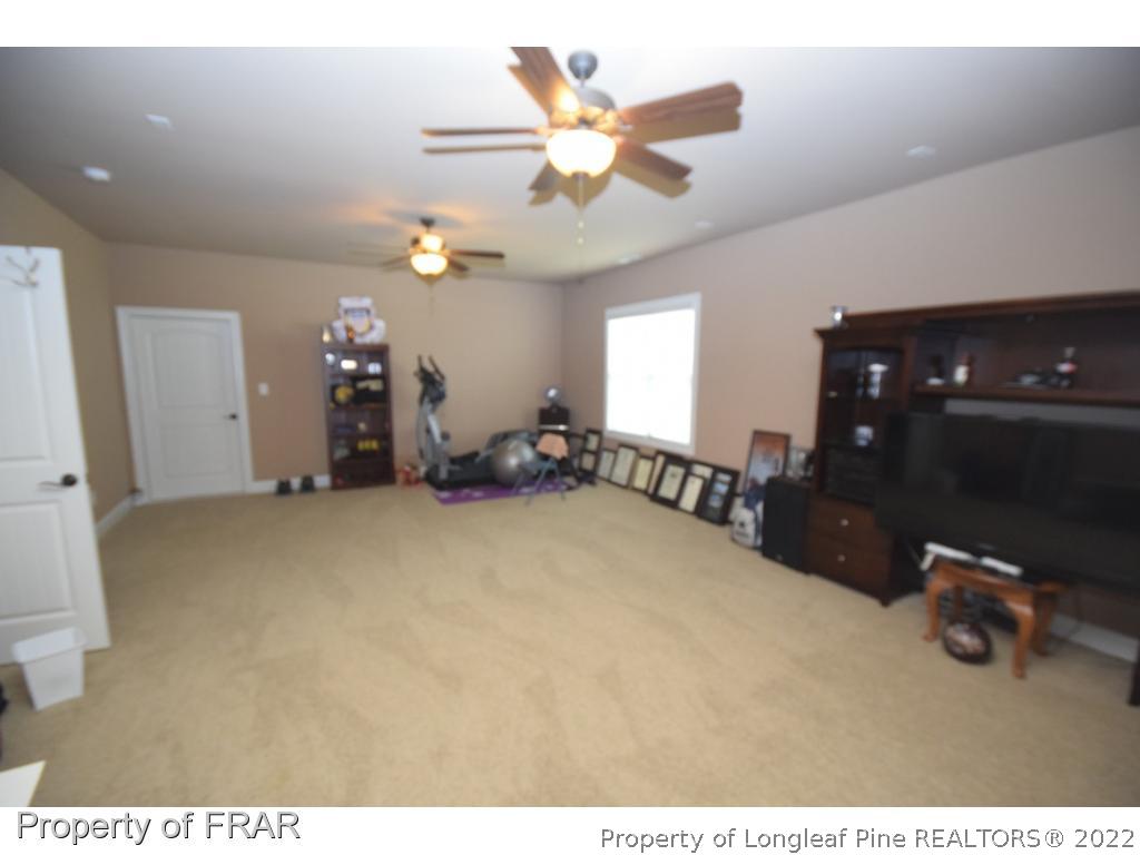 1804 Micahs Way North Spring Lake, NC 28390 - Photo 23 of 30 a room with gym equipment and a chandelier