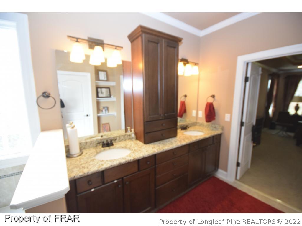 1804 Micahs Way North Spring Lake, NC 28390 - Photo 27 of 30 a bathroom with a double vanity sink and mirror