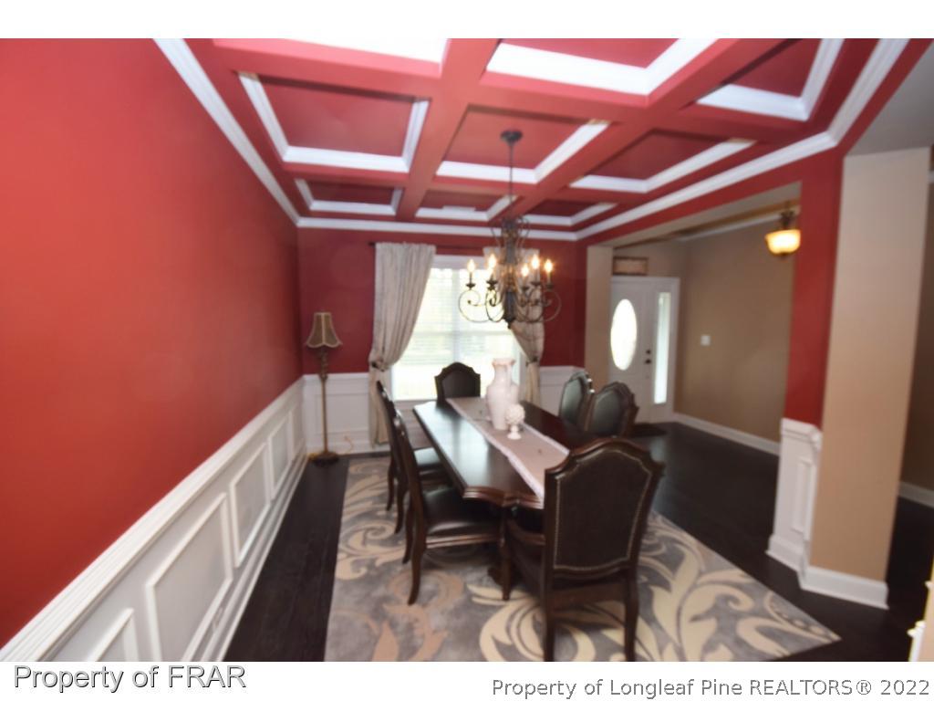 1804 Micahs Way North Spring Lake, NC 28390 - Photo 4 of 30 a view of a dining room with furniture and a chandelier