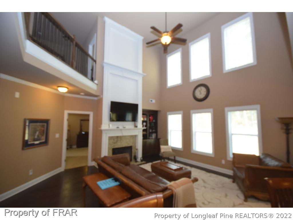 1804 Micahs Way North Spring Lake, NC 28390 - Photo 10 of 30 a living room with furniture a fireplace and a large window