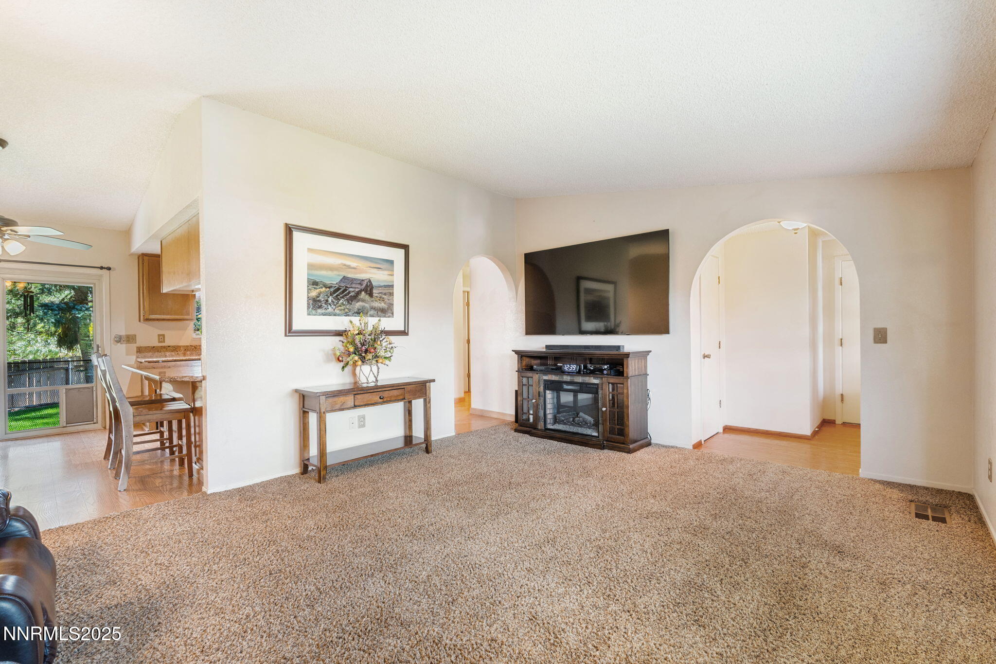 8678 Strutter Way Reno, NV 89506 - Photo 13 of 38 an empty room with furniture and a flat screen tv