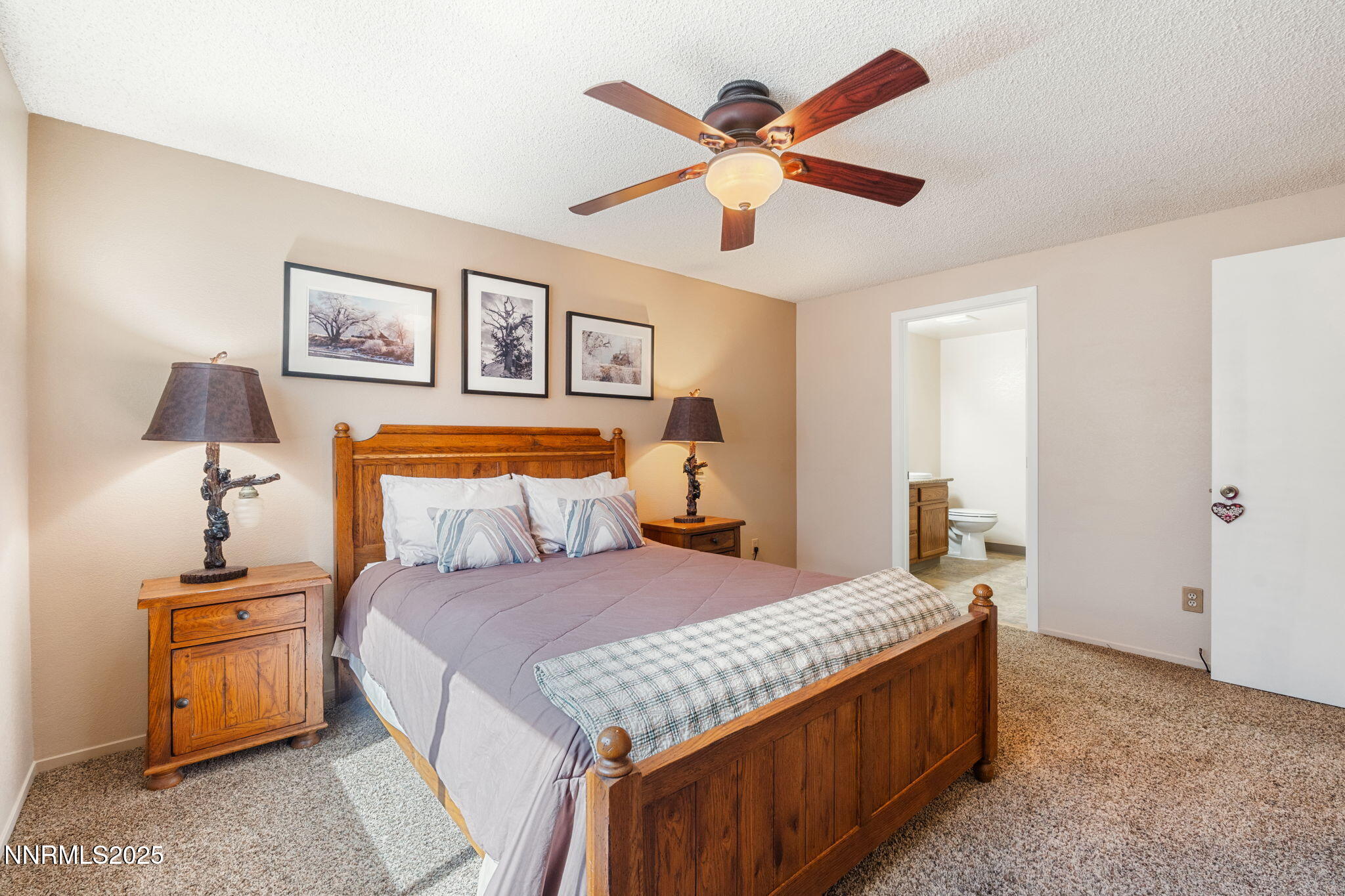 8678 Strutter Way Reno, NV 89506 - Photo 25 of 38 a bedroom with a bed and a chandelier