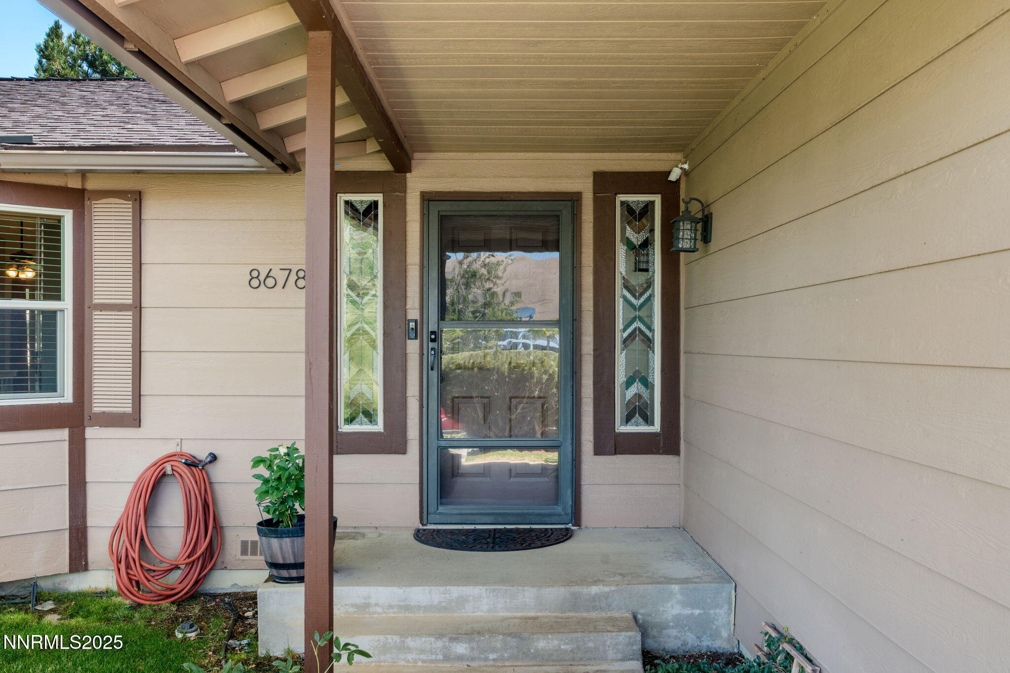 8678 Strutter Way Reno, NV 89506 - Photo 4 of 38 a front view of a house with a garden