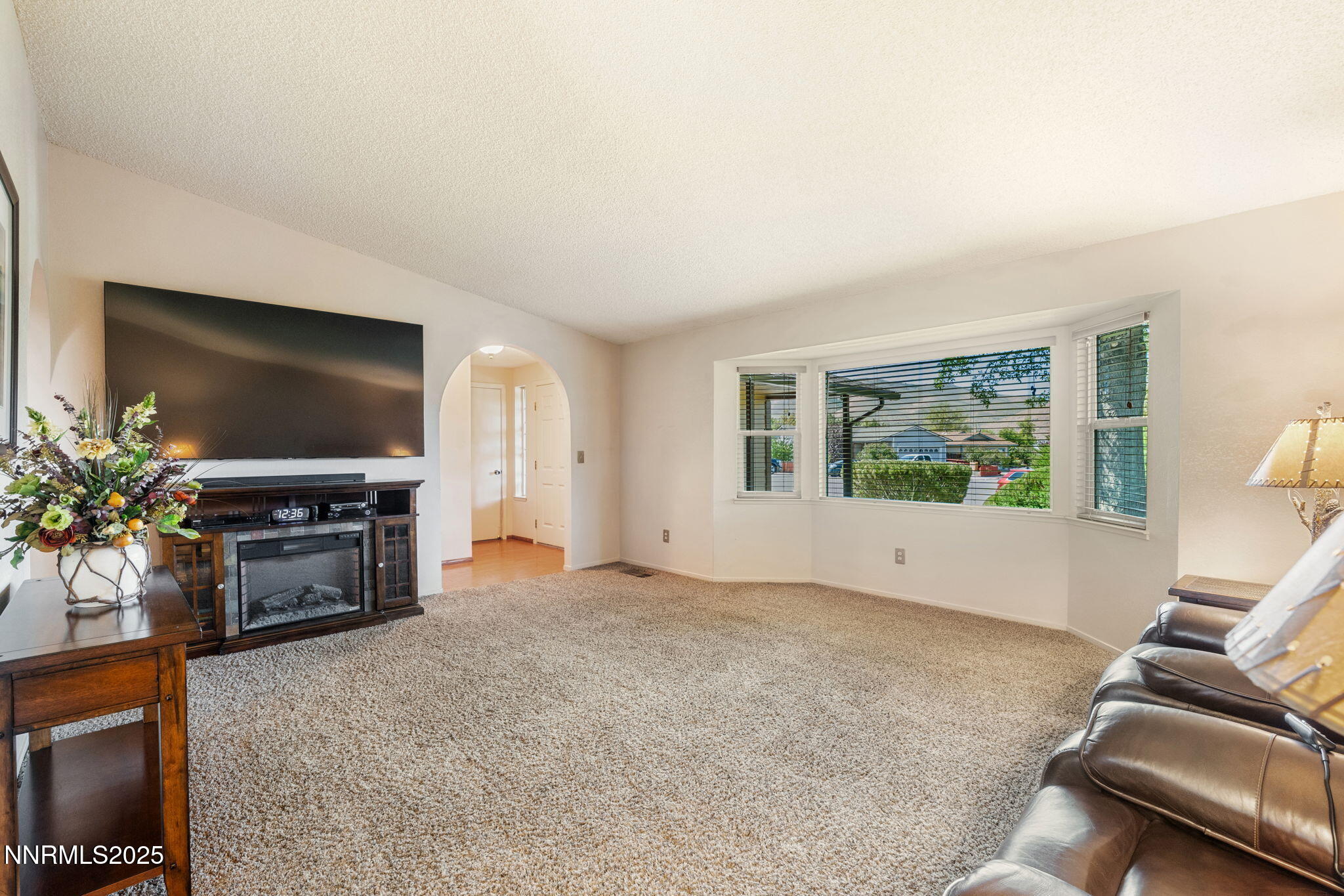 8678 Strutter Way Reno, NV 89506 - Photo 8 of 38 a living room with furniture and a flat screen tv
