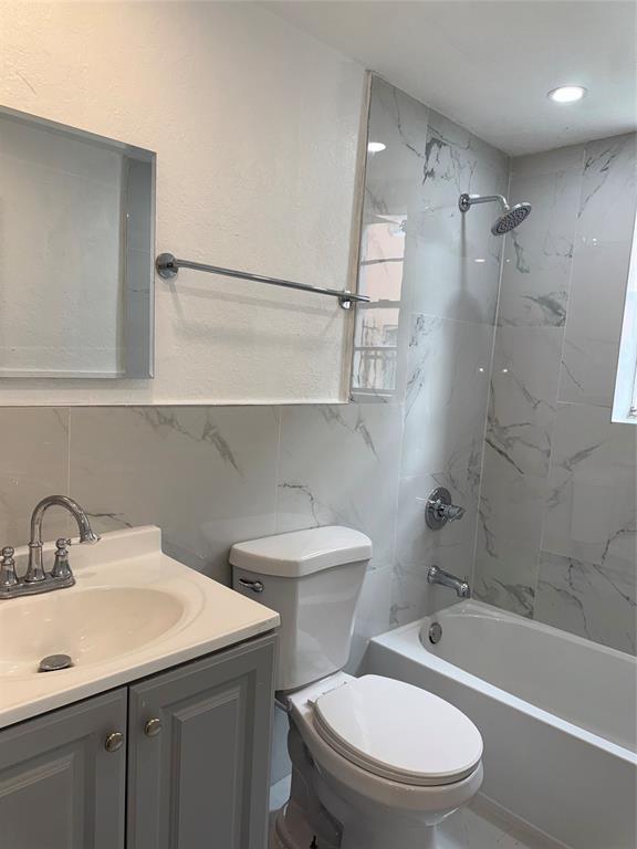 731 Northwest 56th Street, Unit 101 Miami, FL 33127 - Photo 11 of 11 a bathroom with a sink a toilet and shower