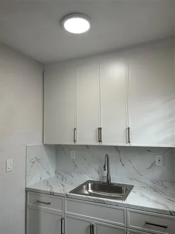 a kitchen with a sink and cabinets