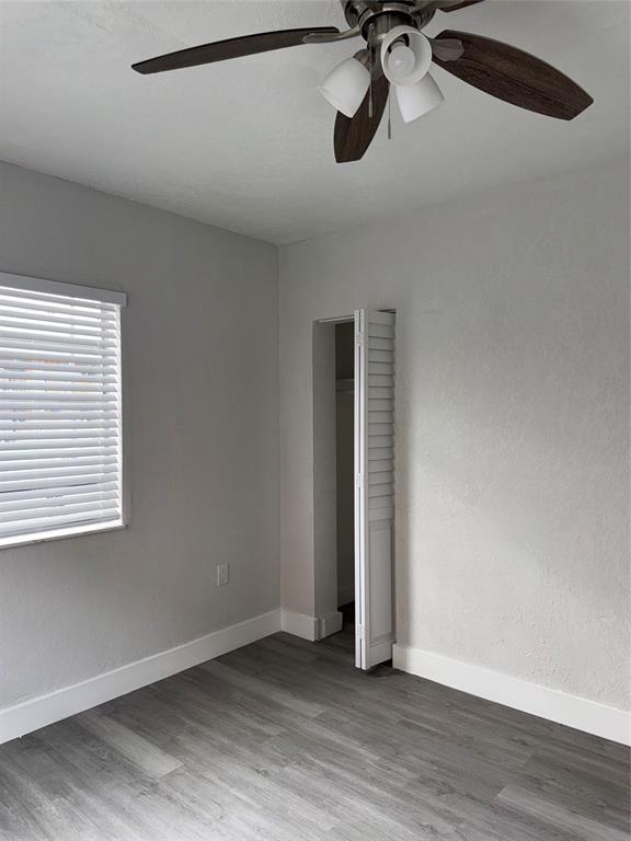 731 Northwest 56th Street, Unit 101 Miami, FL 33127 - Photo 9 of 11 a view of a room with a projector and wooden floor