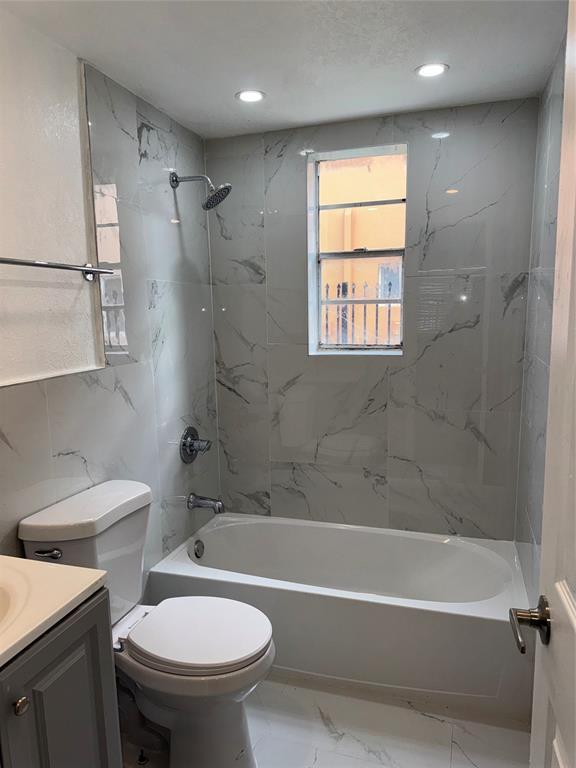731 Northwest 56th Street, Unit 101 Miami, FL 33127 - Photo 10 of 11 a bathroom with a sink toilet and bathtub