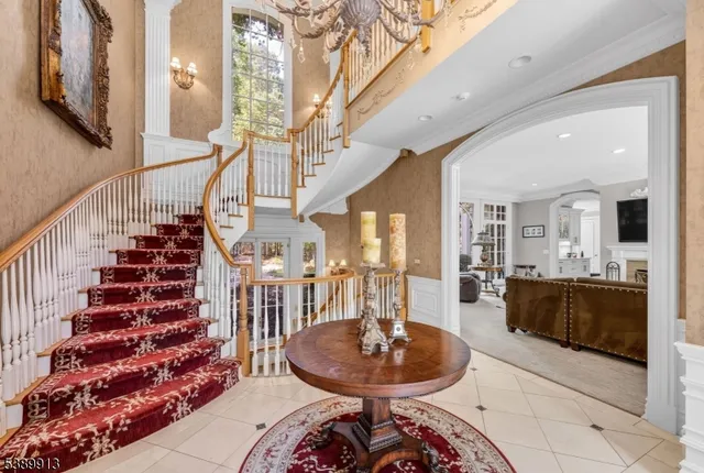 a living room with furniture and a chandelier