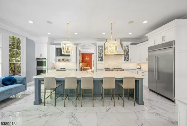 a large kitchen with a table and chairs