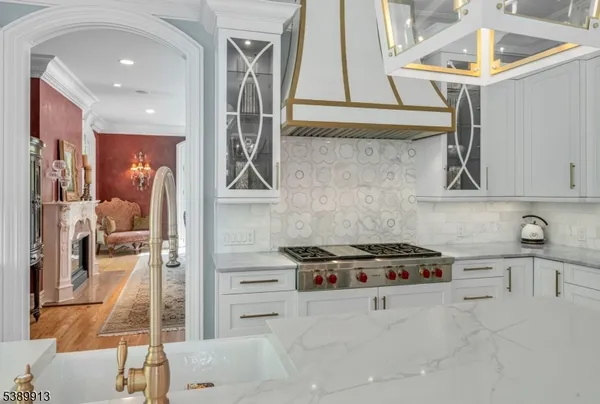 a kitchen with stainless steel appliances kitchen island a white stove top oven and sink