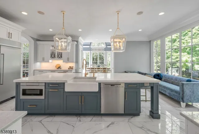 a kitchen with kitchen island granite countertop a sink and a stove